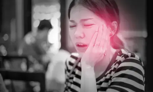 Black and white photo of woman with achy temporomandibular joint highlighted in red.